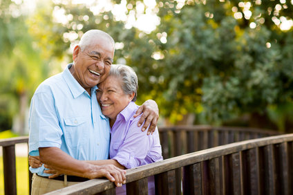 An older couple smiling and showing off their Teeth in a Day.